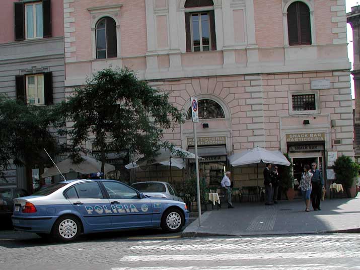a Police car in Rome, in front of a pastry shop